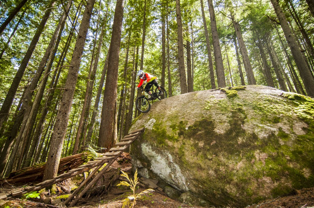 In the thick forest of Boulder Mountain outside of Revelstoke we found an amazing array of well built wood and rock features. Here Colin rolls a steep one. 
