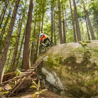 In the thick forest of Boulder Mountain outside of Revelstoke we found an amazing array of well built wood and rock features. Here Colin rolls a steep one.